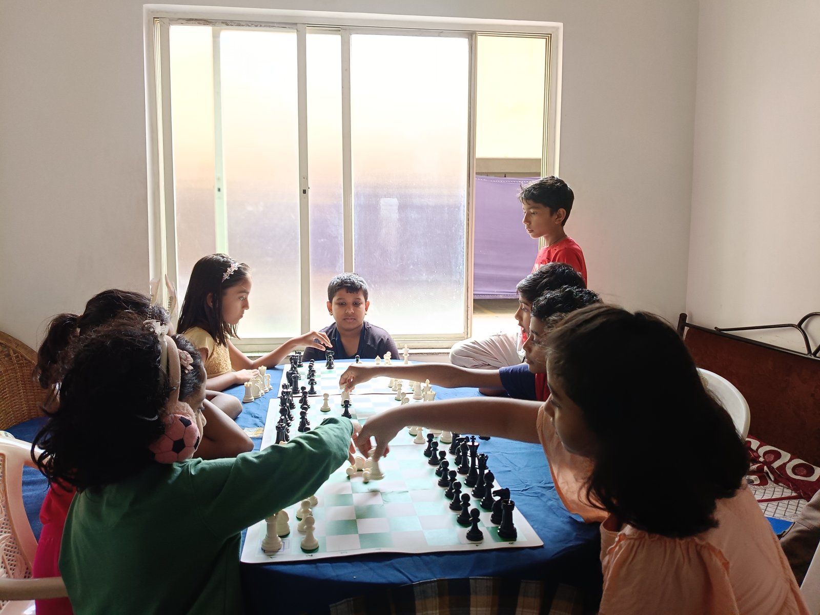 Children learning chess in a classroom
