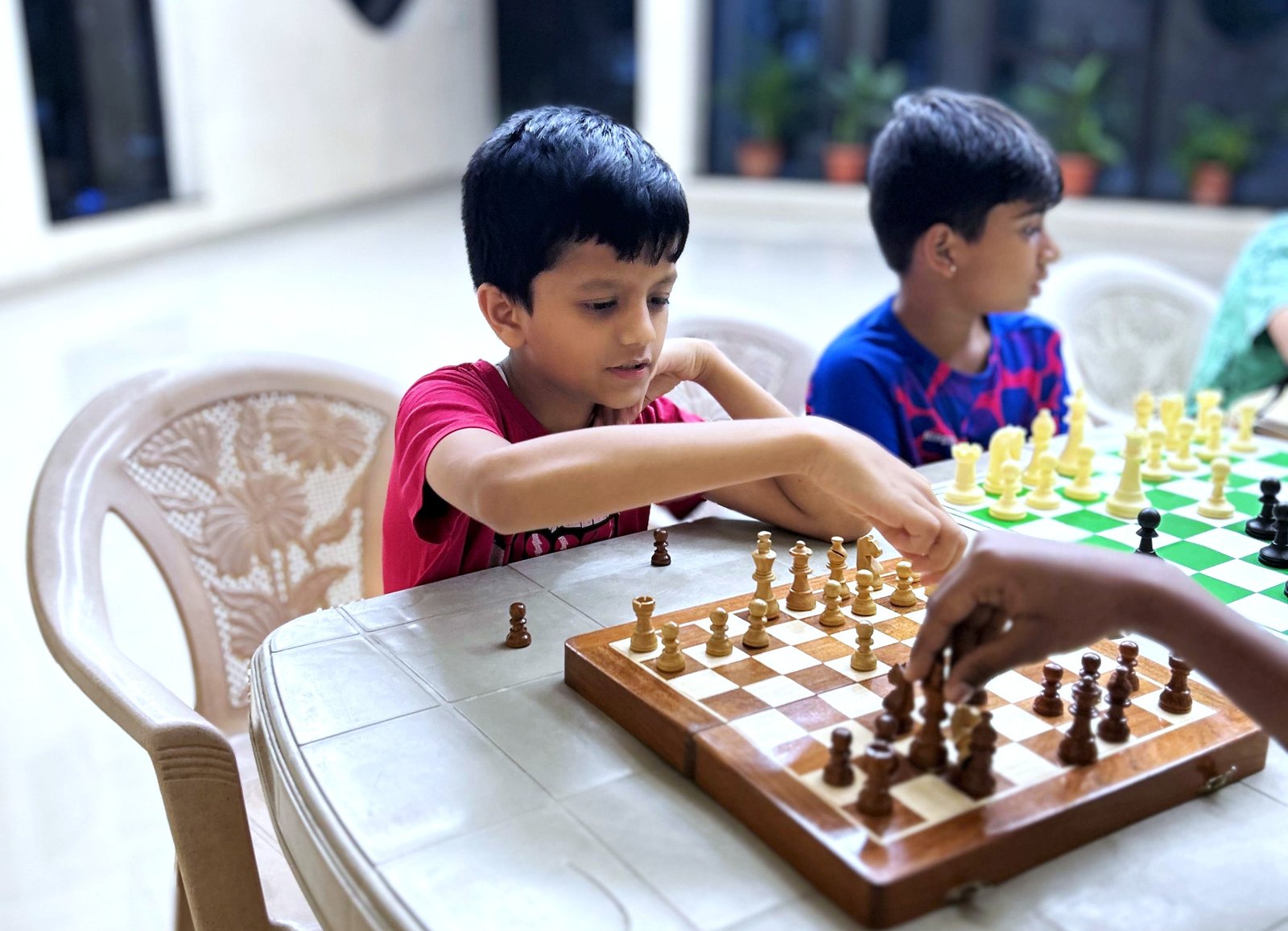 Children learning chess in a classroom setting